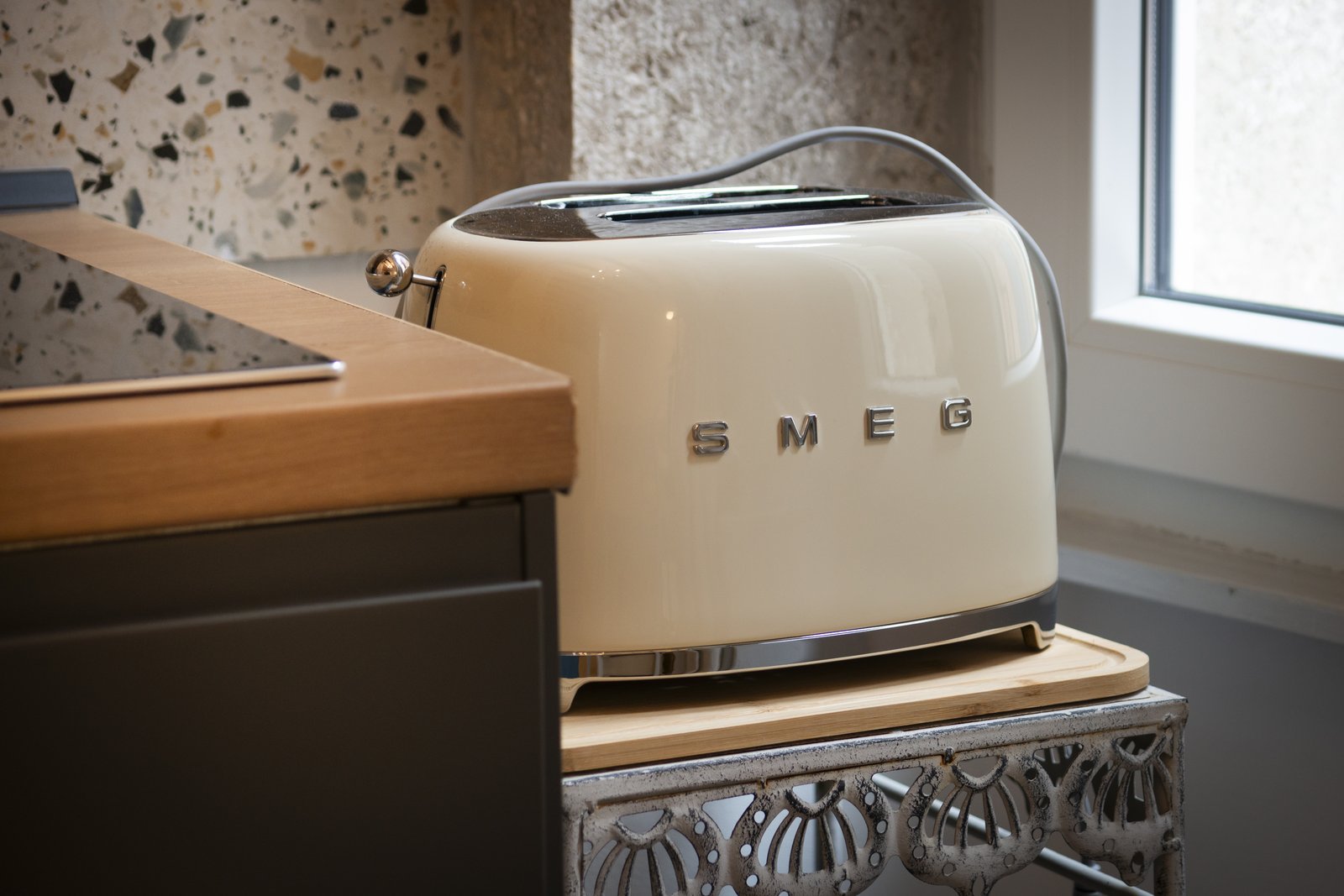 A cream SMEG toaster on the kitchen counter